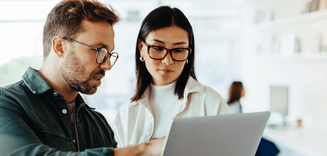 man and woman looking at laptop