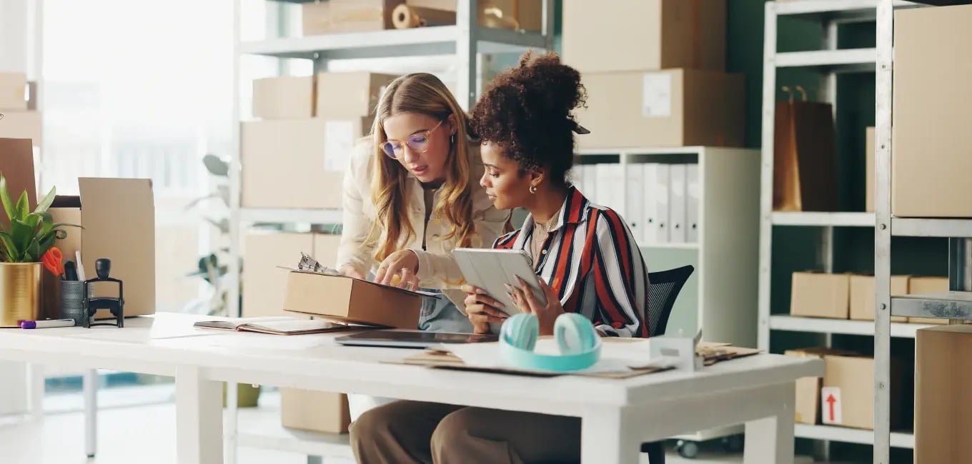 two women looking at a clipboard